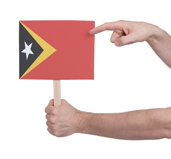 Hand met kleine kaartje - vlag van Oost-Timor — Stockfoto