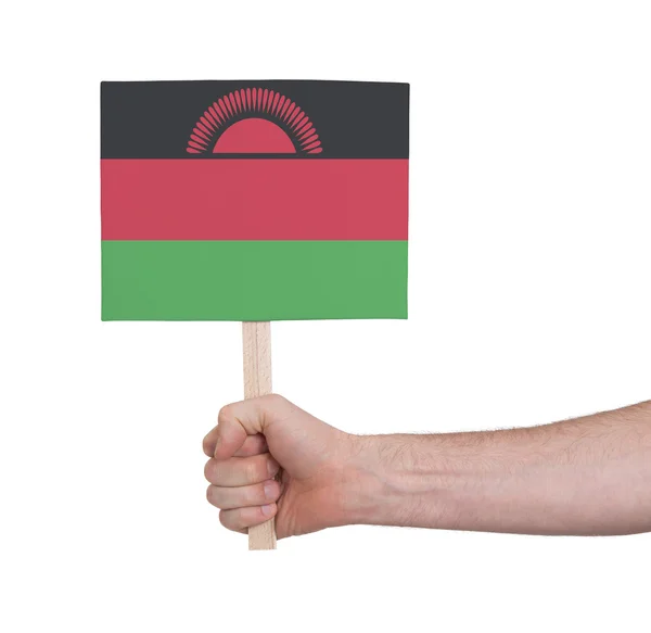 Hand hält kleine Karte - Flagge von Malawi — Stockfoto