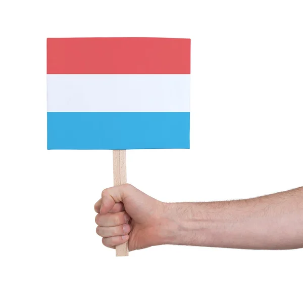 Hand met kleine kaartje - vlag van Luxemburg — Stockfoto