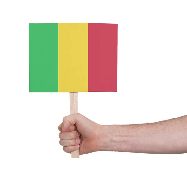 Mão segurando cartão pequeno - Bandeira do Mali — Fotografia de Stock