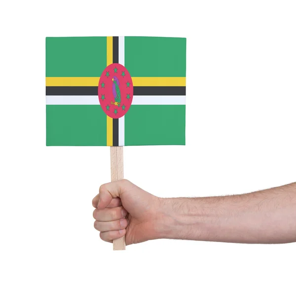 Mano sosteniendo una tarjeta pequeña - Bandera de Dominica — Foto de Stock