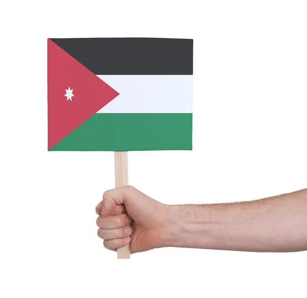 Hand hält kleine Karte - jordanische Flagge — Stockfoto