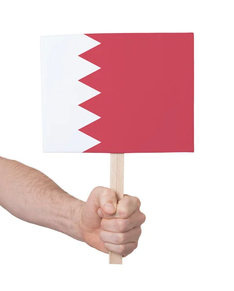 Mano che tiene piccola carta - Bandiera del Bahrein — Foto Stock