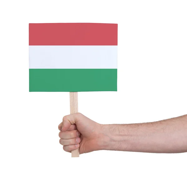 Hand met kleine kaartje - vlag van Hongarije — Stockfoto