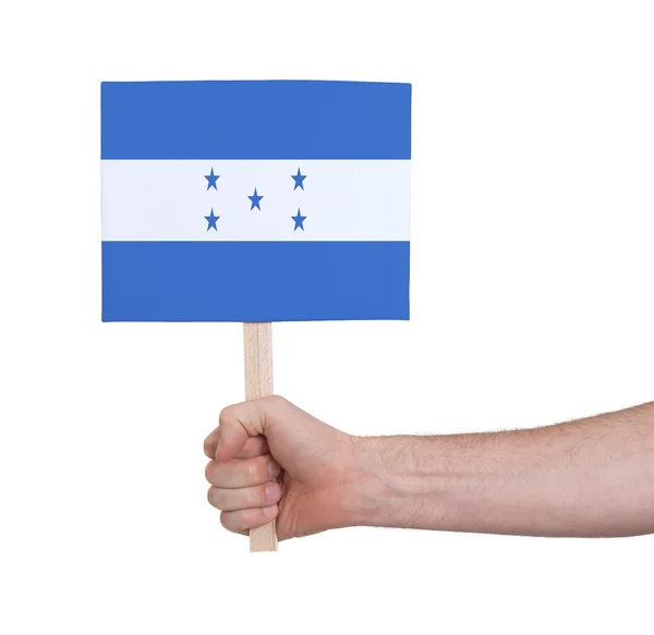 Mano sosteniendo tarjeta pequeña - Bandera de Honduras — Foto de Stock