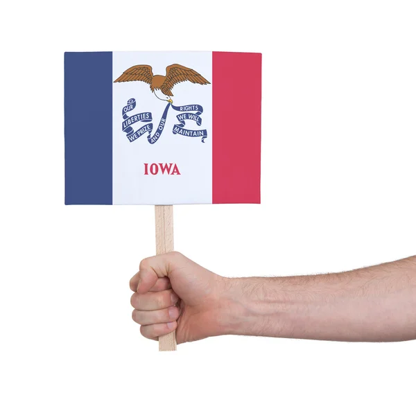 Hand met kleine kaartje - vlag van Iowa — Stockfoto