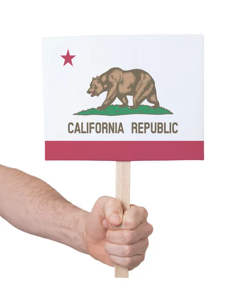 Mano sosteniendo una tarjeta pequeña - Bandera de California — Foto de Stock