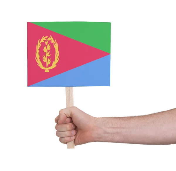 Mão segurando cartão pequeno - Bandeira da Eritreia — Fotografia de Stock