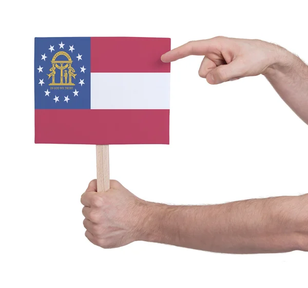 Рука с маленькой карточкой - Флаг Грузии — стоковое фото