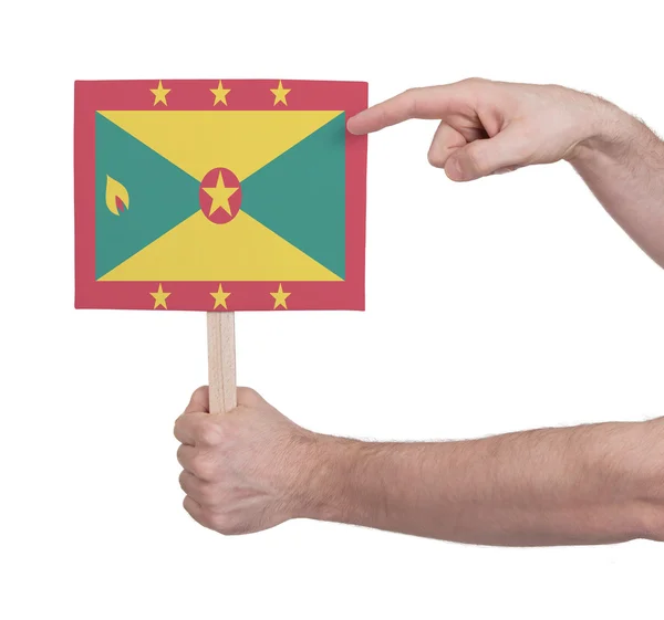 Mano sosteniendo una tarjeta pequeña - Bandera de Granada — Foto de Stock