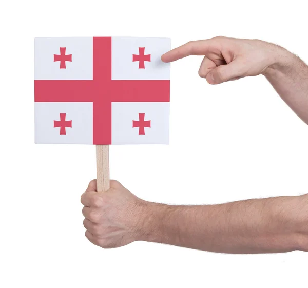 Mão segurando cartão pequeno - Bandeira da Geórgia — Fotografia de Stock