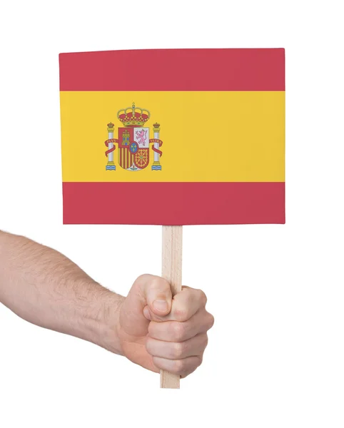 Hand som håller litet kort - flagga i Spanien — Stockfoto