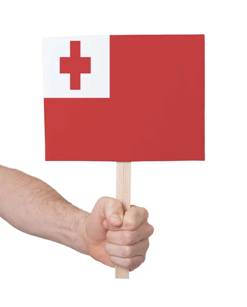 Mão segurando cartão pequeno - Bandeira de Tonga — Fotografia de Stock