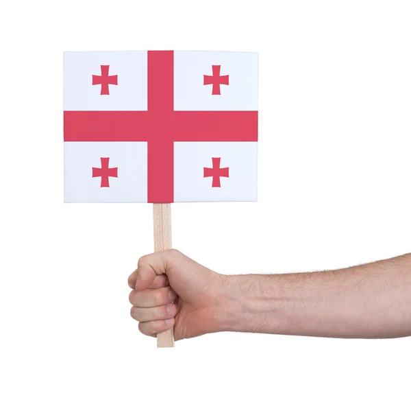 Hand met kleine kaartje - vlag van Georgië — Stockfoto