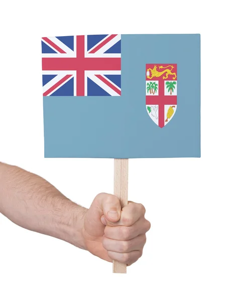 Hand som håller litet kort - flagga Fiji — Stockfoto