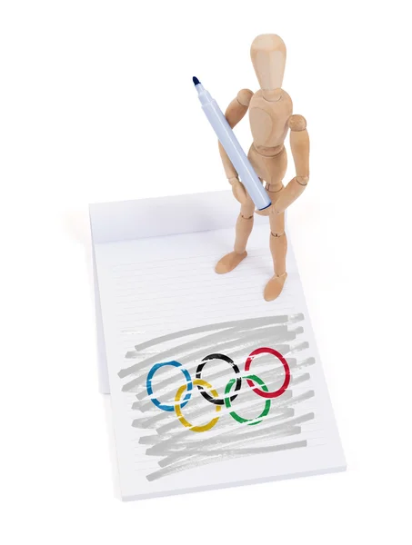 Mannequin en bois fait un dessin - Anneaux olympiques — Photo