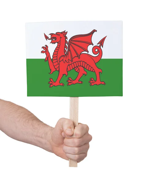 Mão segurando cartão pequeno - Bandeira de Gales — Fotografia de Stock