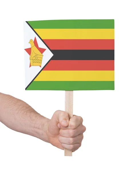 Hand holding small card - Flag of Zimbabwe — Stock Photo, Image