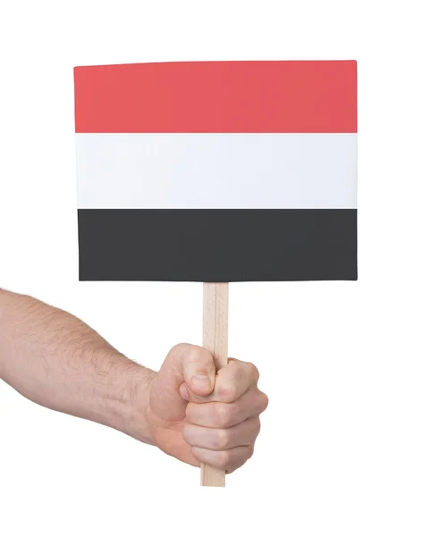 Mano sosteniendo una tarjeta pequeña - Bandera de Yemen — Foto de Stock