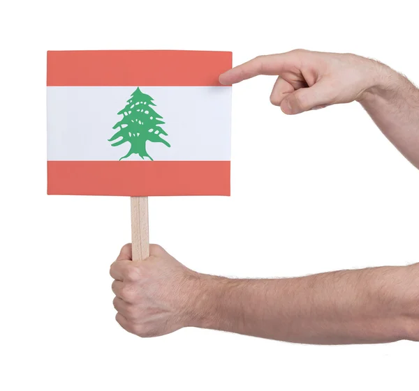 Hand holding small card - Flag of Lebanon — Stock Photo, Image