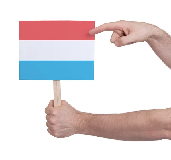 Hand holding small card - Flag of Luxembourg — Stock Photo, Image