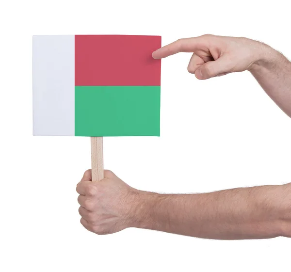 Ręka gospodarstwa małe karty - flaga Madagaskaru — Zdjęcie stockowe