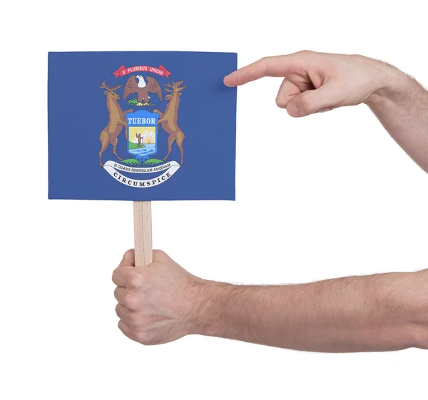 Mano sosteniendo una tarjeta pequeña - Bandera de Michigan — Foto de Stock