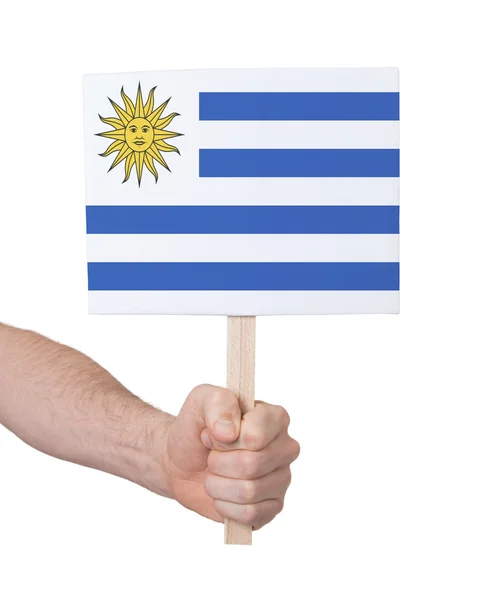 Hand holding small card - Flag of Uruguay — Stock Photo, Image