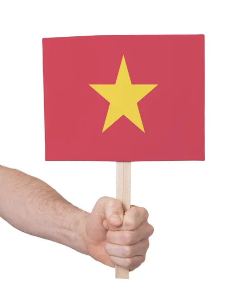 Hand met kleine kaartje - vlag van Vietnam — Stockfoto