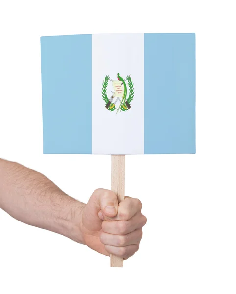 Mão segurando cartão pequeno - Bandeira da Guatemala — Fotografia de Stock