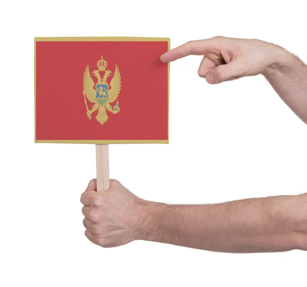 Mano sosteniendo una tarjeta pequeña - Bandera de Montenegro —  Fotos de Stock