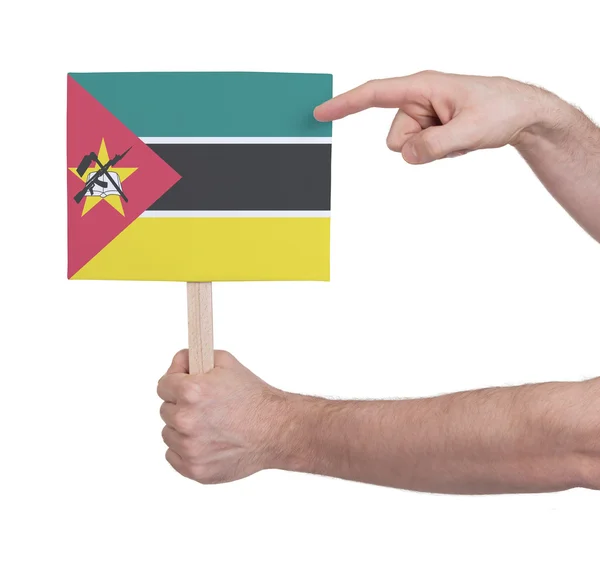 Hand met kleine kaartje - vlag van Mozambique — Stockfoto