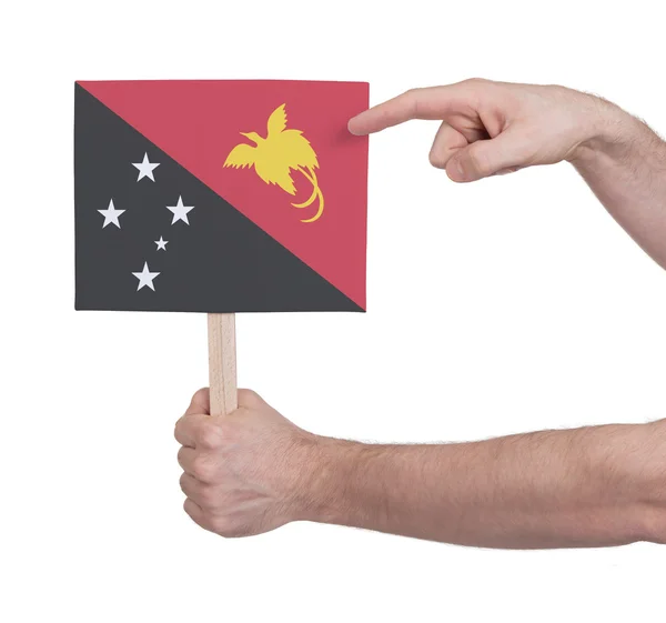 Hand holding small card - Flag of Papua New Guinea — Stock Photo, Image