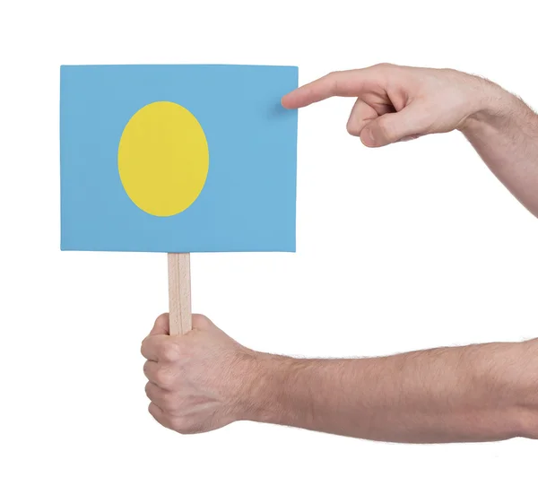Hand hält kleine Karte - Flagge von Palau — Stockfoto
