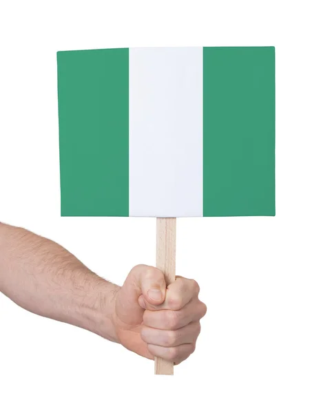 Mano che tiene piccola carta - Bandiera della Nigeria — Foto Stock