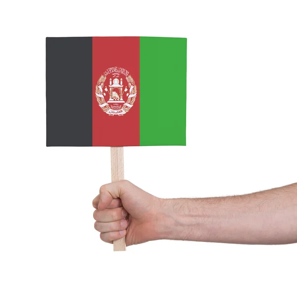 Mão segurando cartão pequeno - Bandeira do Afeganistão — Fotografia de Stock
