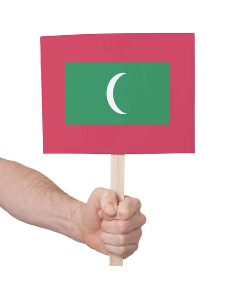 Hand met kleine kaartje - vlag van de Maldiven — Stockfoto