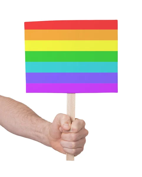 Hand met kleine kaartje - vlag van Regenboogvlag — Stockfoto