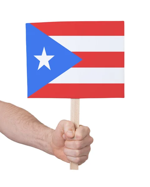 Hand som håller litet kort - flagga i Puerto Rico — Stockfoto