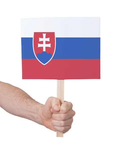 Руки, що тримає невелика картка - прапор Словаччини — стокове фото