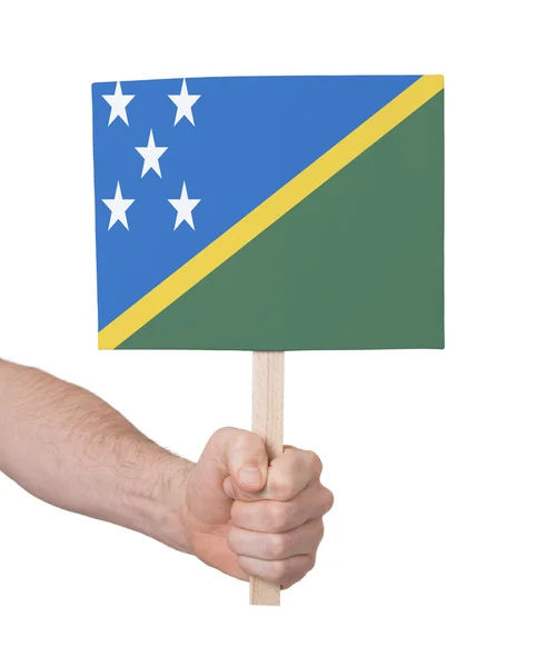 Hand holding small card - Flag of Solomon Islands — Stock Photo, Image