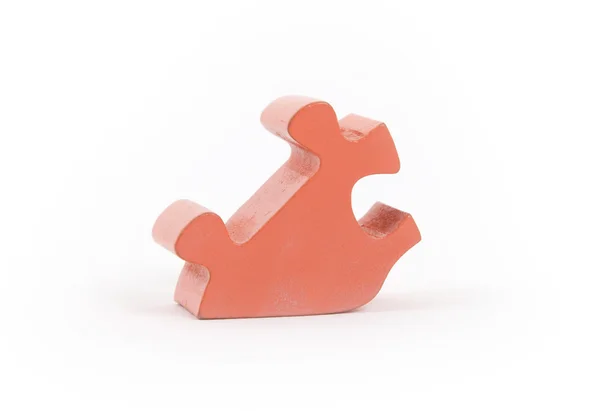 Closeup of big orange jigsaw puzzle piece — Stock Photo, Image