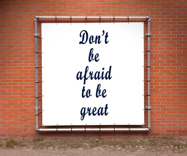 Large banner with inspirational quote on a brick wall — Stock Photo, Image