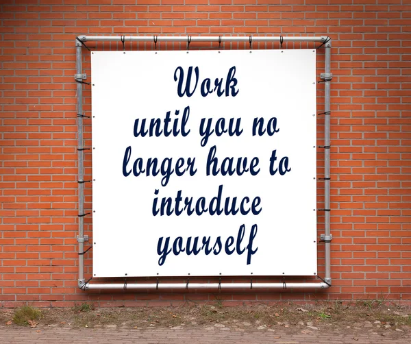 Large banner with inspirational quote on a brick wall — Stock Photo, Image
