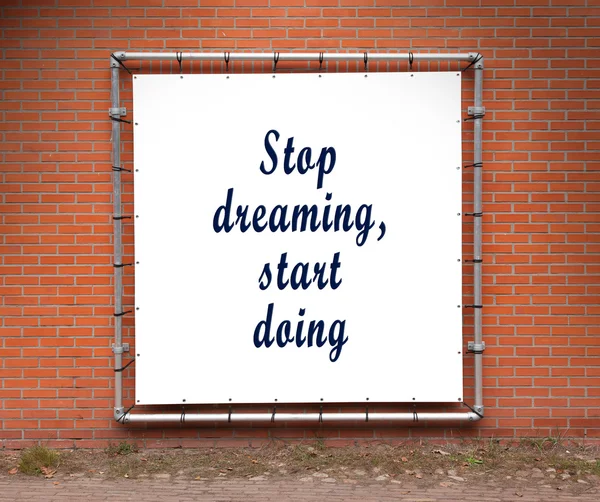 Large banner with inspirational quote on a brick wall — Stock Photo, Image