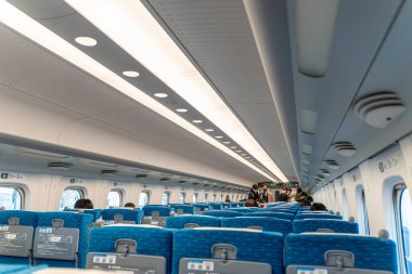 Osaka şehri, Japonya - 10 Aralık 2024: Yolcu taşıyan bir N700 Serie Shinkansen yüksek hız treninin perspektif görüntüsü ve iç mekanı.