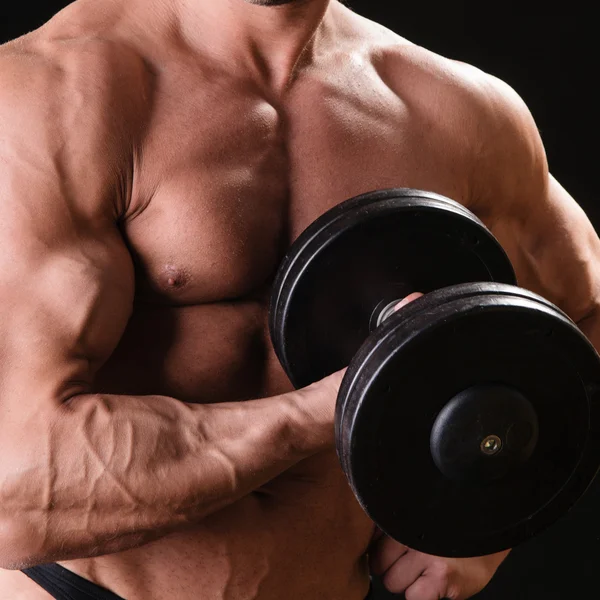 Muscular bodybuilder with dumbbell — Stock Photo, Image