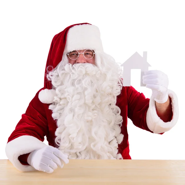 Santa Claus håller papper house — Stockfoto