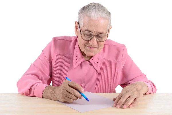 Elderly woman writes the document — Stock Photo, Image