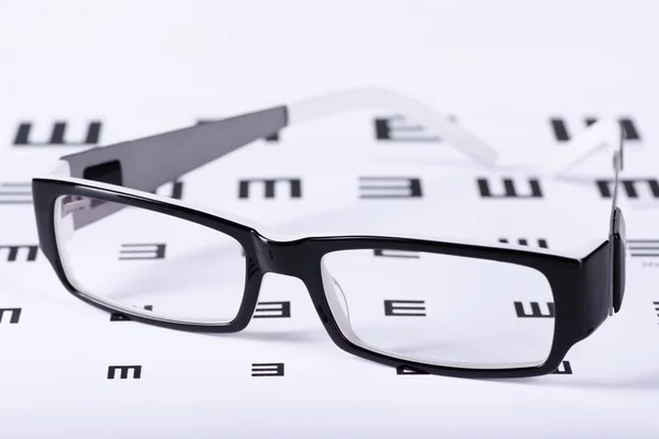 Eyeglasses and eye chart — Stock Photo, Image